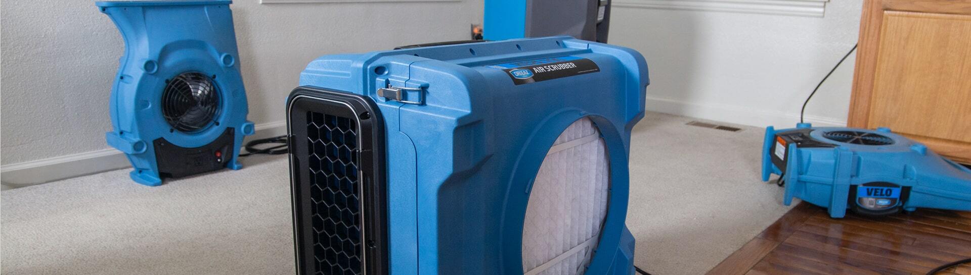 Blue air scrubber unit filtering smoke in the air.