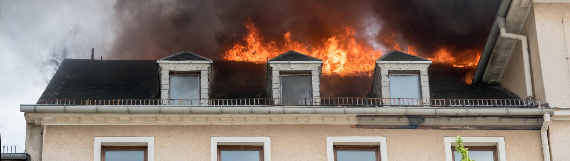 House with flames burning across the roof.