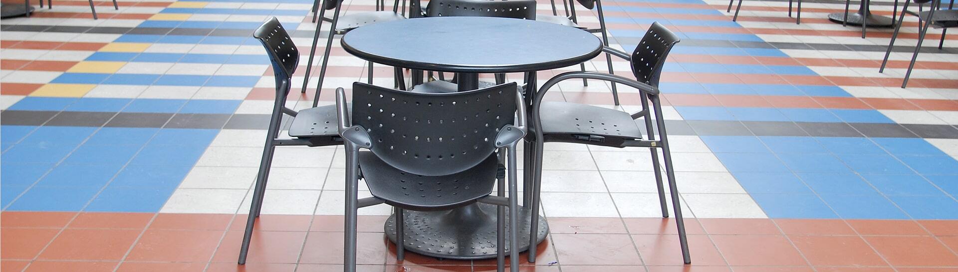 Chairs and tables on a tiled hard-surface floor.