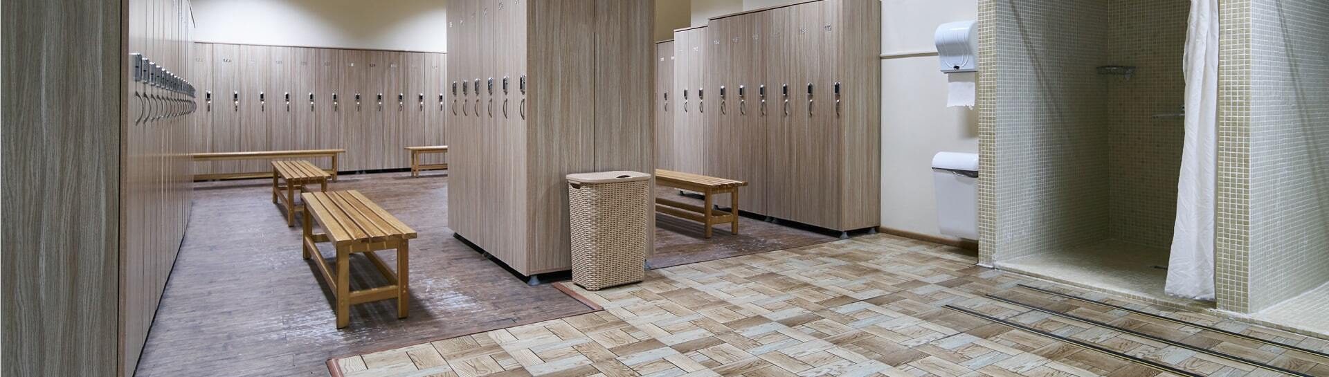 Locker room with wood lockers and a woven hamper.