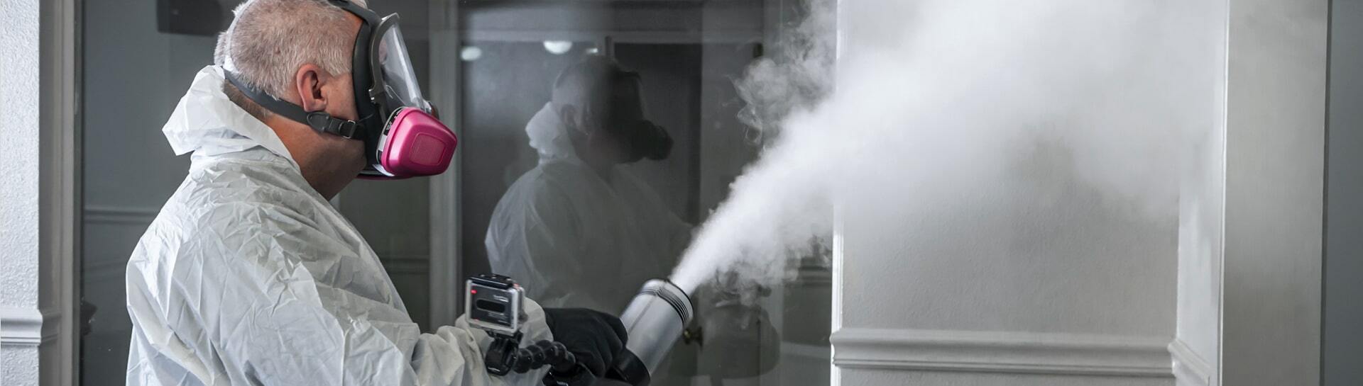 Technician releasing a fog of deodorizing spray.