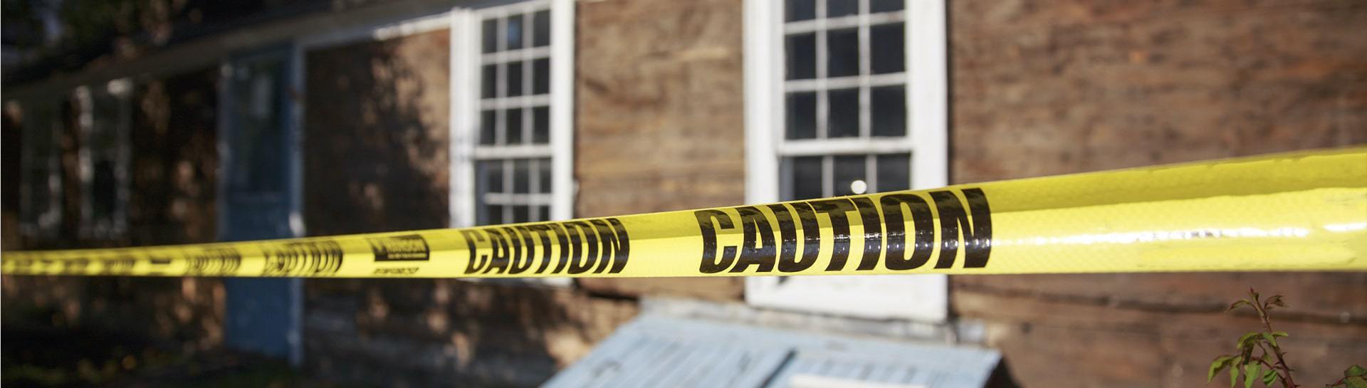 House exterior blocked off with yellow caution tape.