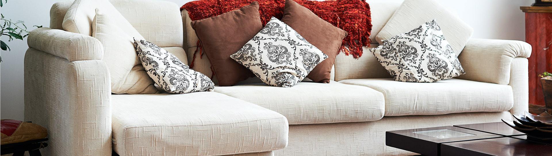 Couch with patterned pillows in a living room.