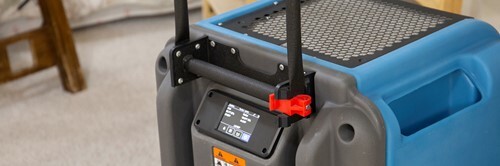 Blue restoration dehumidifier with control panel and handle.